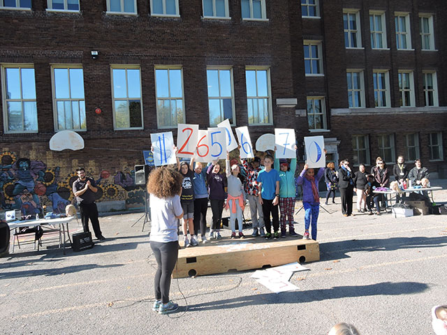 students holding the total of the fundraiser