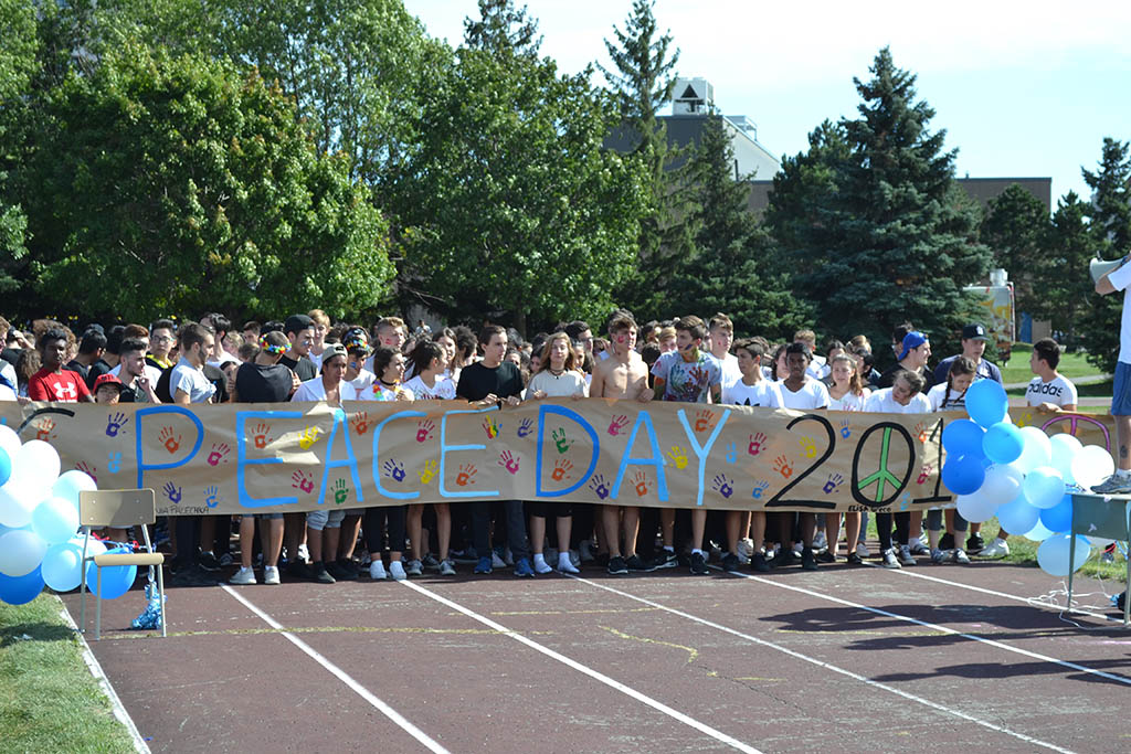 crowd of students with a peace sign