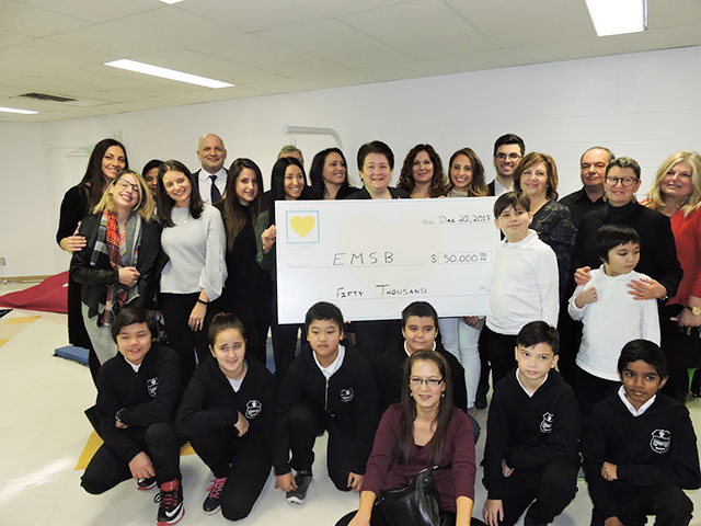 teachers and students with a big cheque