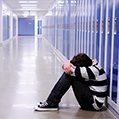 boy alone in an empty corridor with blue lockers icon