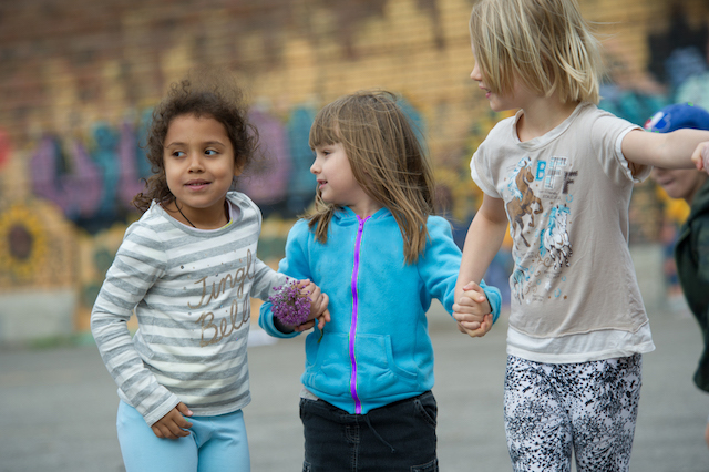 Girls holding hands in schoolyard