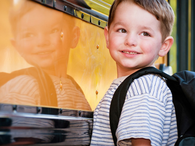 kid in front of school bus