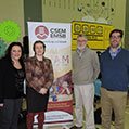 four people standing in front of a EMSB banner