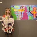 Alana Barrell poses in front of her "Birds" painting at CAP Gallery in Montreal, on display as part of her Fabulous Bestiary exhibition. Photo: J. Stoopler