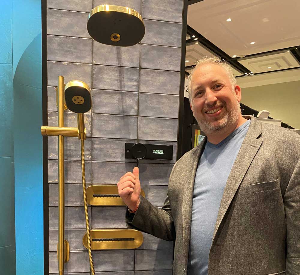 Ben Levine showing a new Kohler shower faucet  at a trade show on November 1. Photo courtesy of Levine Bros.