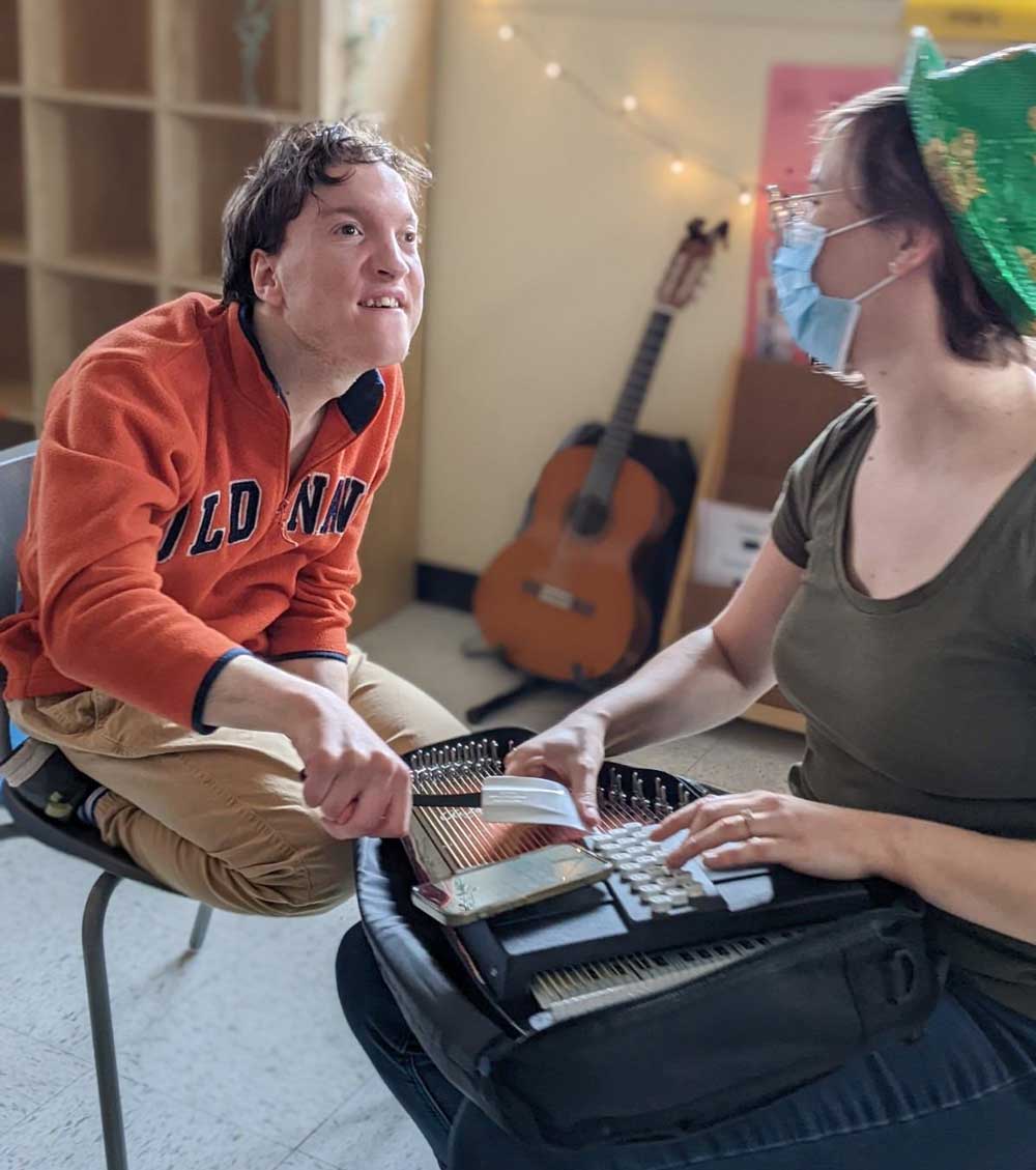 Student at Peter Hall celebrated Saint Patrick's Day by playing Irish songs on the autoharp with music therapist, Katie Komorek. Photos courtesy of Peter Hall School