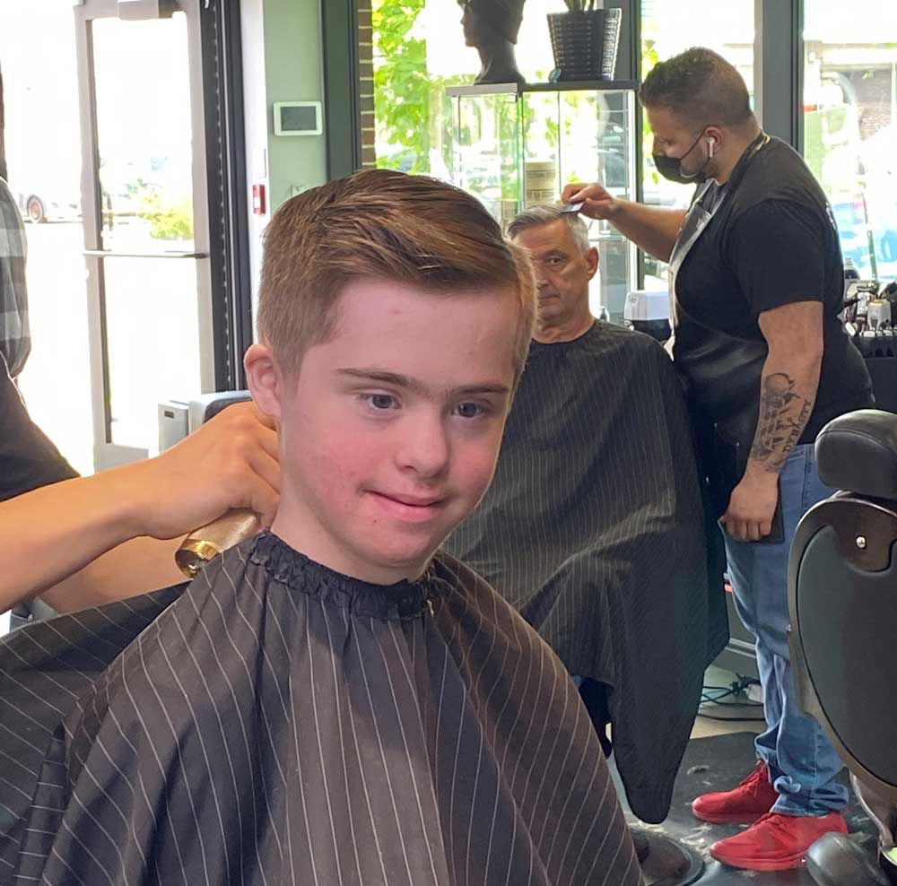 A look of pride on Kian’s face as he receives his first haircut in August. Photo courtesy of S. Lynch