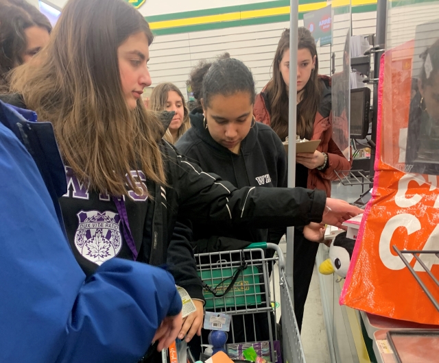 Students choose items to make up the wellness boxes during a shopping expedition in February 2023.