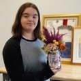 Alessia Iglio shows off her creation, in the fall of 2023, as part of her work with Summit Flora, Summit School’s work-oriented training program for students.