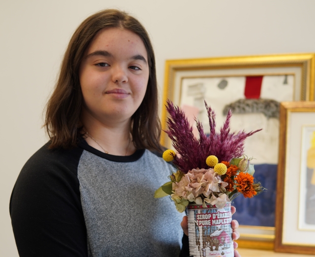 Alessia Iglio shows off her creation, in the fall of 2023, as part of her work with Summit Flora, Summit School’s work-oriented training program for students.