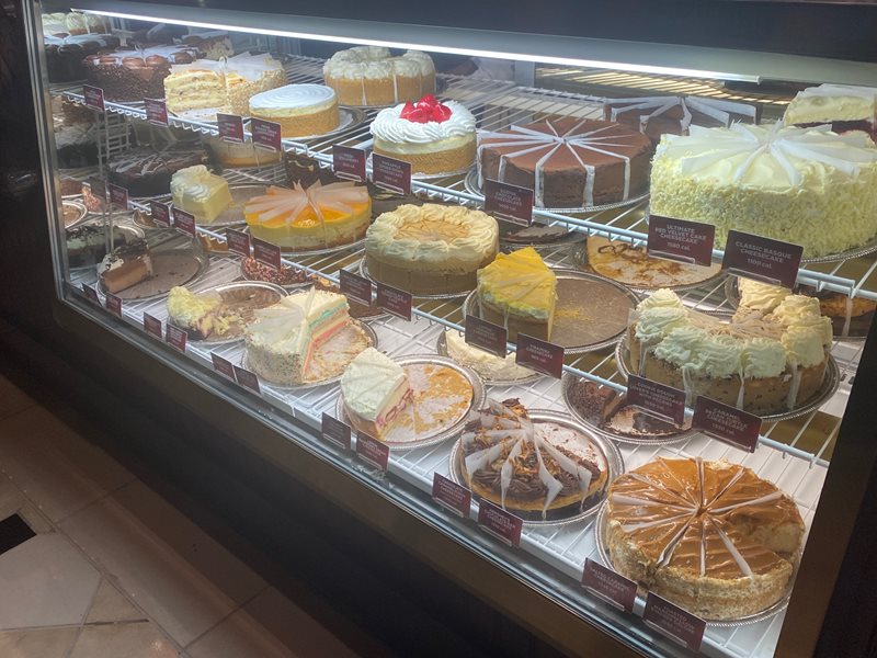 The display of delicious cheesecakes.